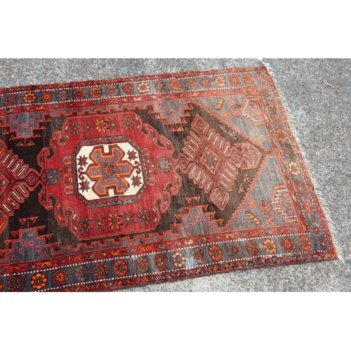 1164 - Persian handwoven wool carpet of red ground, central medallion, showing wear & age, approx 135cm x 2... 