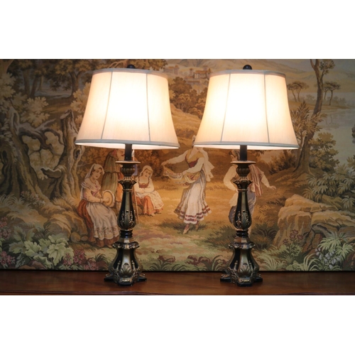 1209 - Pair of decorative black and gilt table lamps, cream shantung shades, in working order at the time o... 