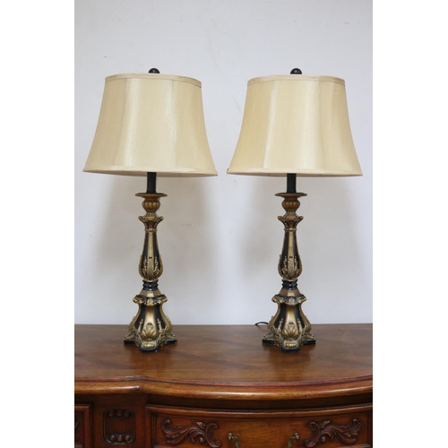 1209 - Pair of decorative black and gilt table lamps, cream shantung shades, in working order at the time o... 