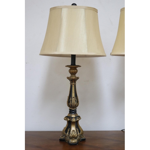 1209 - Pair of decorative black and gilt table lamps, cream shantung shades, in working order at the time o... 