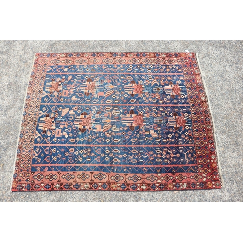 1226 - Persian handwoven wool carpet of blue & red ground, approx 158cm x 130cm