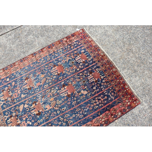 1226 - Persian handwoven wool carpet of blue & red ground, approx 158cm x 130cm