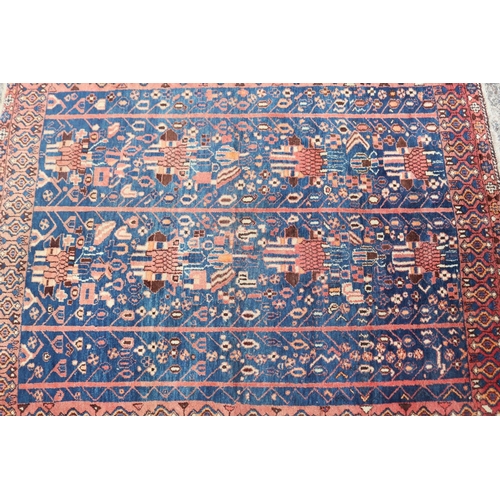 1226 - Persian handwoven wool carpet of blue & red ground, approx 158cm x 130cm