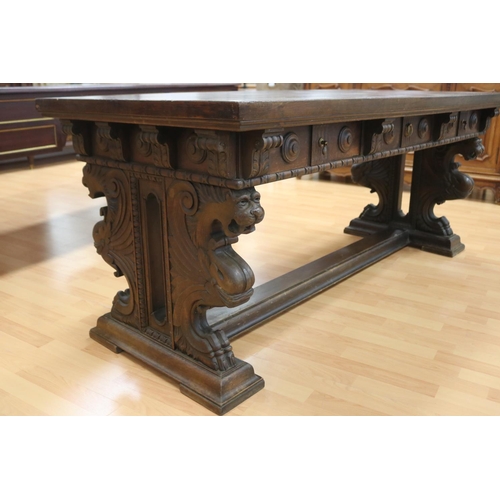 1218 - Antique French Henri II desk standing on a stretcher base, carved griffin terms to either end, appro... 