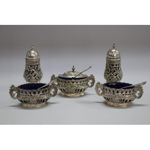 1257 - Antique cruet set consisting of three sterling silver salts along with two pepper pots, Birmingham 1... 