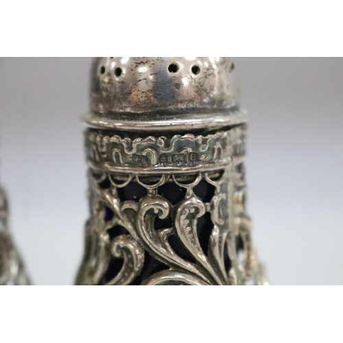 1257 - Antique cruet set consisting of three sterling silver salts along with two pepper pots, Birmingham 1... 