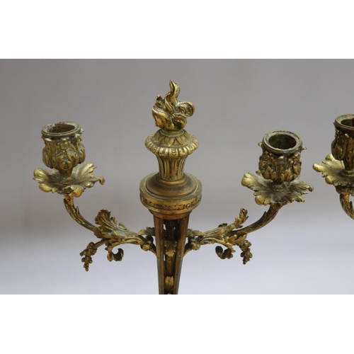 1326 - Pair of antique French Louis XVI revival bronze two stick candelabra, each with central flaming torc... 