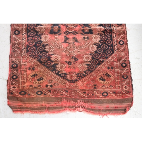 420 - Small handwoven carpet of red ground, approx 120cm L x 84cm W