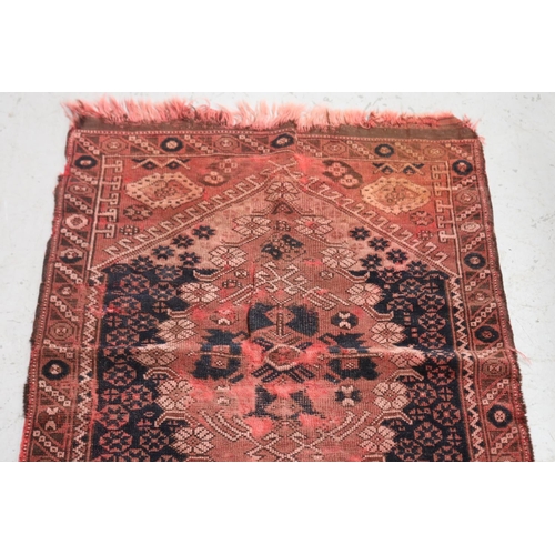 420 - Small handwoven carpet of red ground, approx 120cm L x 84cm W