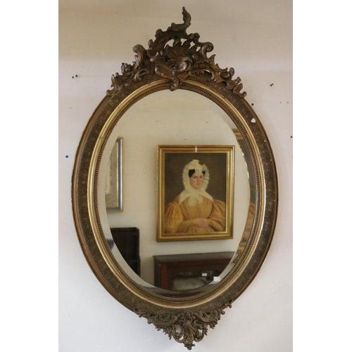 1064 - Antique French Louis XV style gilt framed oval wall mirror with C scroll crest to top, approx 122cm ... 