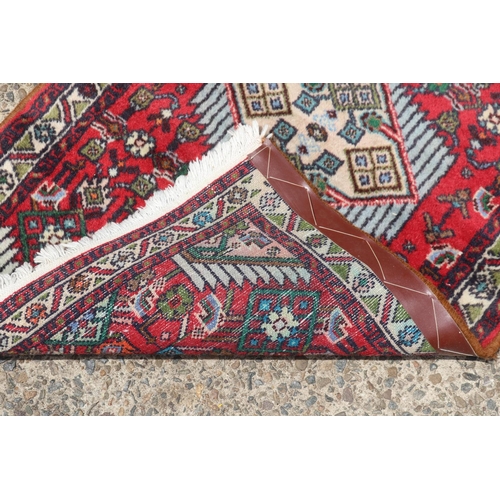 1109 - Persian hand knotted wool carpet, approx 64cm x 104cm