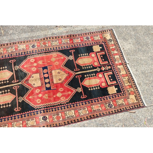 1138 - Handwoven carpet of red and black ground, Geometric design, approx 146cm x 257cm