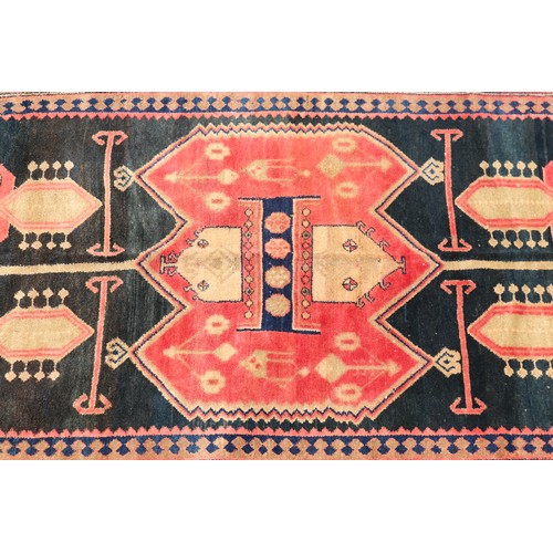 1138 - Handwoven carpet of red and black ground, Geometric design, approx 146cm x 257cm