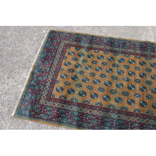 1147 - Handwoven red and brown ground carpet, approx 166cm x 238cm