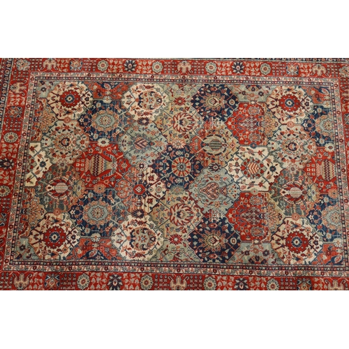 1060 - Persian style woollen garden pattern carpet, approx 180cm x 125cm