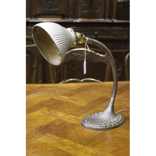 1179 - Vintage cast metal based desk lamp, adjustable arm and shell shade, in working condition at time of ... 