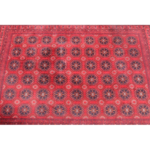 173 - Hand woven red ground carpet, approx 238cm x 162cm