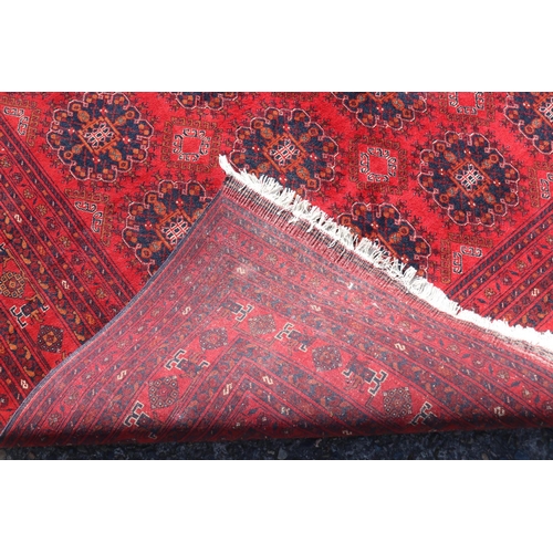 173 - Hand woven red ground carpet, approx 238cm x 162cm