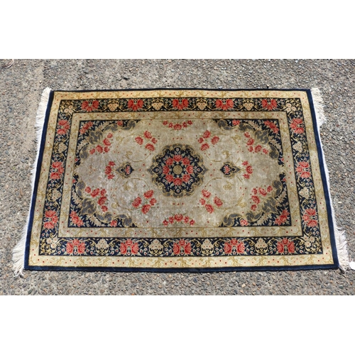 175 - Persian silk carpet with a design of stylised flower heads, approx 118cm x 77cm