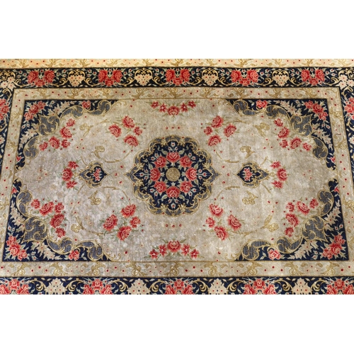 175 - Persian silk carpet with a design of stylised flower heads, approx 118cm x 77cm