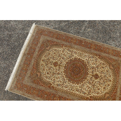 187 - Silk Qum carpet with central medallion on ivory field, inscribed to one end, approx 147cm x 99cm