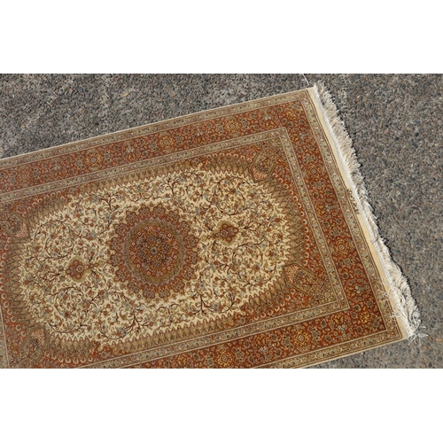 187 - Silk Qum carpet with central medallion on ivory field, inscribed to one end, approx 147cm x 99cm