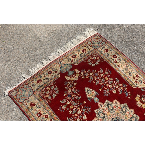 232 - Persian silk carpet with a lobed medallion on claret field with Shah Abbas flowers, approx 238cm x 1... 