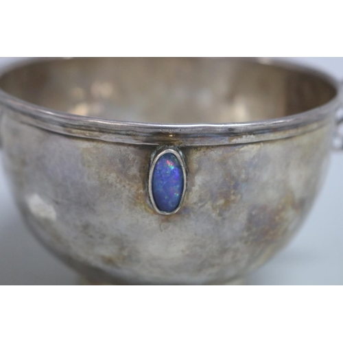 6 - Hammered sterling silver twin handled bowl set with two cabochon opals in the style of Liberty, indi... 