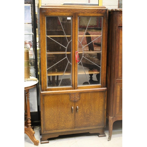 1172 - English oak Art Deco bookcase with lead glazing bars, with adjustable internal shelves, below a two ... 