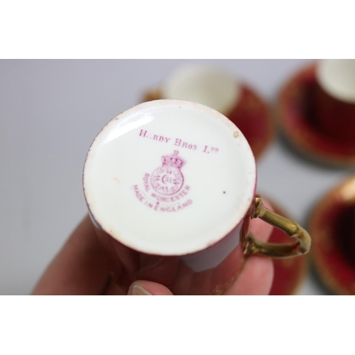 118 - Set of four crimson ground Royal Worcester coffee cans and saucers, retailed by Hardy Bros (4)