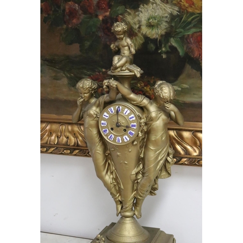 235 - French gold painted spelter mantle clock surmounted by two maidens and a putto, has key (in office D... 