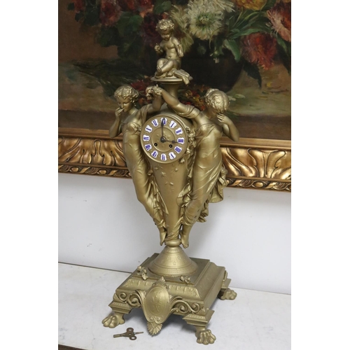 235 - French gold painted spelter mantle clock surmounted by two maidens and a putto, has key (in office D... 