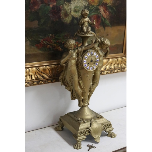 235 - French gold painted spelter mantle clock surmounted by two maidens and a putto, has key (in office D... 