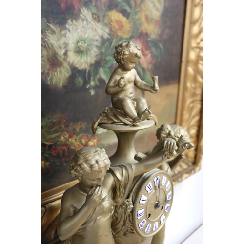 235 - French gold painted spelter mantle clock surmounted by two maidens and a putto, has key (in office D... 