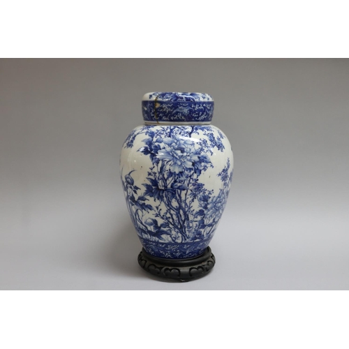 168 - Japanese porcelain covered jar decorated in blue and white birds and peonies (AF) on stand, total ap... 