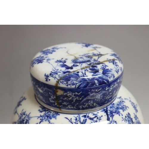 168 - Japanese porcelain covered jar decorated in blue and white birds and peonies (AF) on stand, total ap... 