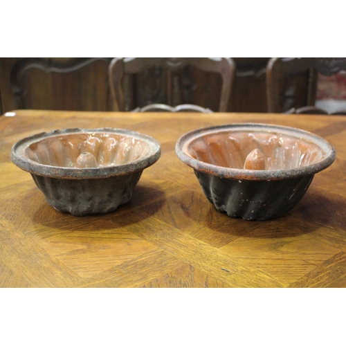1155 - Two antique French pottery bundt moulds, approx 10cm H x 24cm Dia and smaller (2)