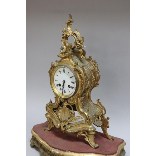 167 - Gilt metal Rococo style mantle clock on stand, has two keys and pendulum (in office D3615-1-109), un... 