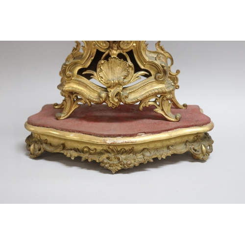 167 - Gilt metal Rococo style mantle clock on stand, has two keys and pendulum (in office D3615-1-109), un... 