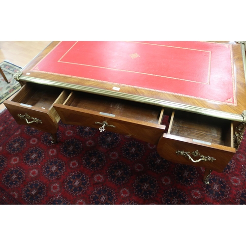 171 - French Louis XV style bureau plat, with tooled red leather writing surface, brass banded edge, and c... 