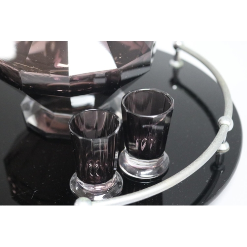 179 - Art Deco cut amethyst glass liqueur set of decanter and four glasses on a circular black glass tray,... 