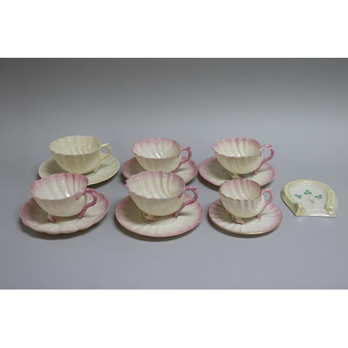 183 - Set of four Belleek teacups and saucers sets and a smaller coffee cup ensuite in the form of shells,... 