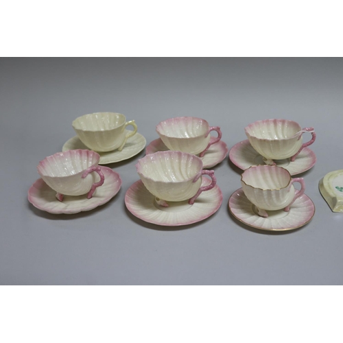 183 - Set of four Belleek teacups and saucers sets and a smaller coffee cup ensuite in the form of shells,... 