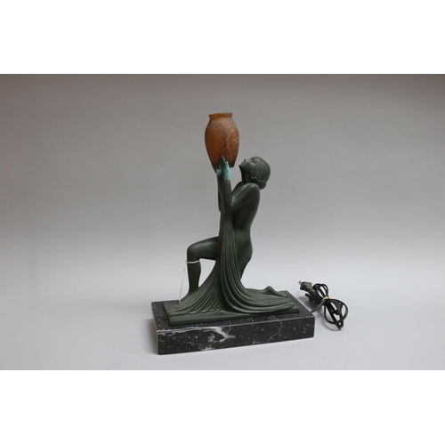 202 - Art Deco bronze table lamp in the form of a kneeling woman holding an amber glass vase, signed Guerl... 