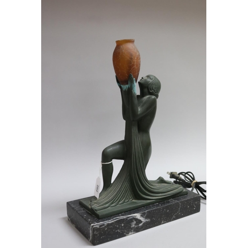 202 - Art Deco bronze table lamp in the form of a kneeling woman holding an amber glass vase, signed Guerl... 