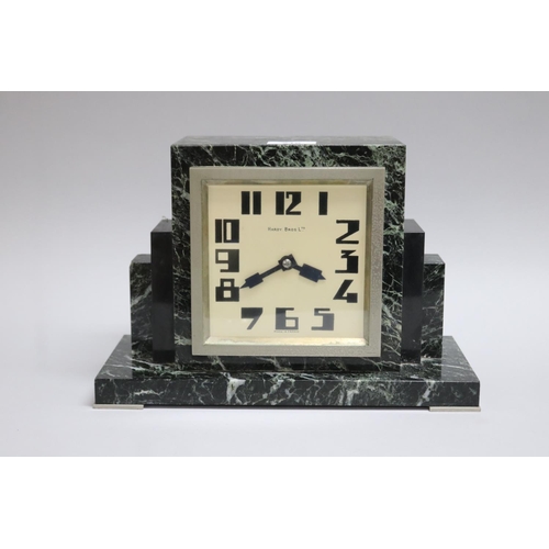 219 - Art Deco green marble mantle clock retailed by Hardy Bros Ltd, has key (in office D3615-1-389), unte... 