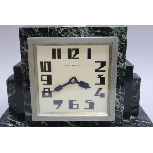 219 - Art Deco green marble mantle clock retailed by Hardy Bros Ltd, has key (in office D3615-1-389), unte... 