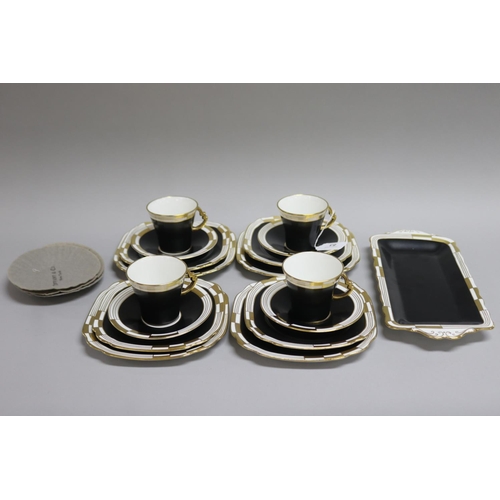 83 - Royal Albert black and white gilt highlights, four sets of tea cups, saucers and plates & a cake/san... 