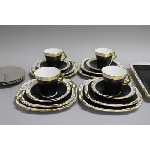 83 - Royal Albert black and white gilt highlights, four sets of tea cups, saucers and plates & a cake/san... 