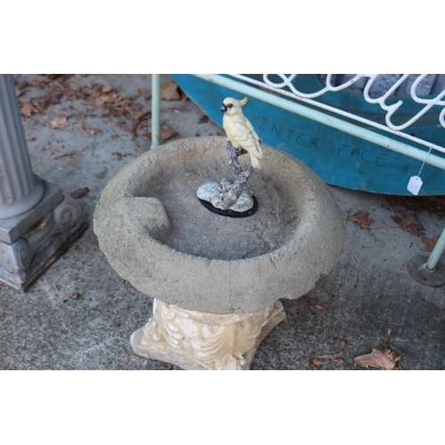 1661 - Composite stone garden bird bath with bird figure, standing on a capital, approx 56cm H x 40cm Dia